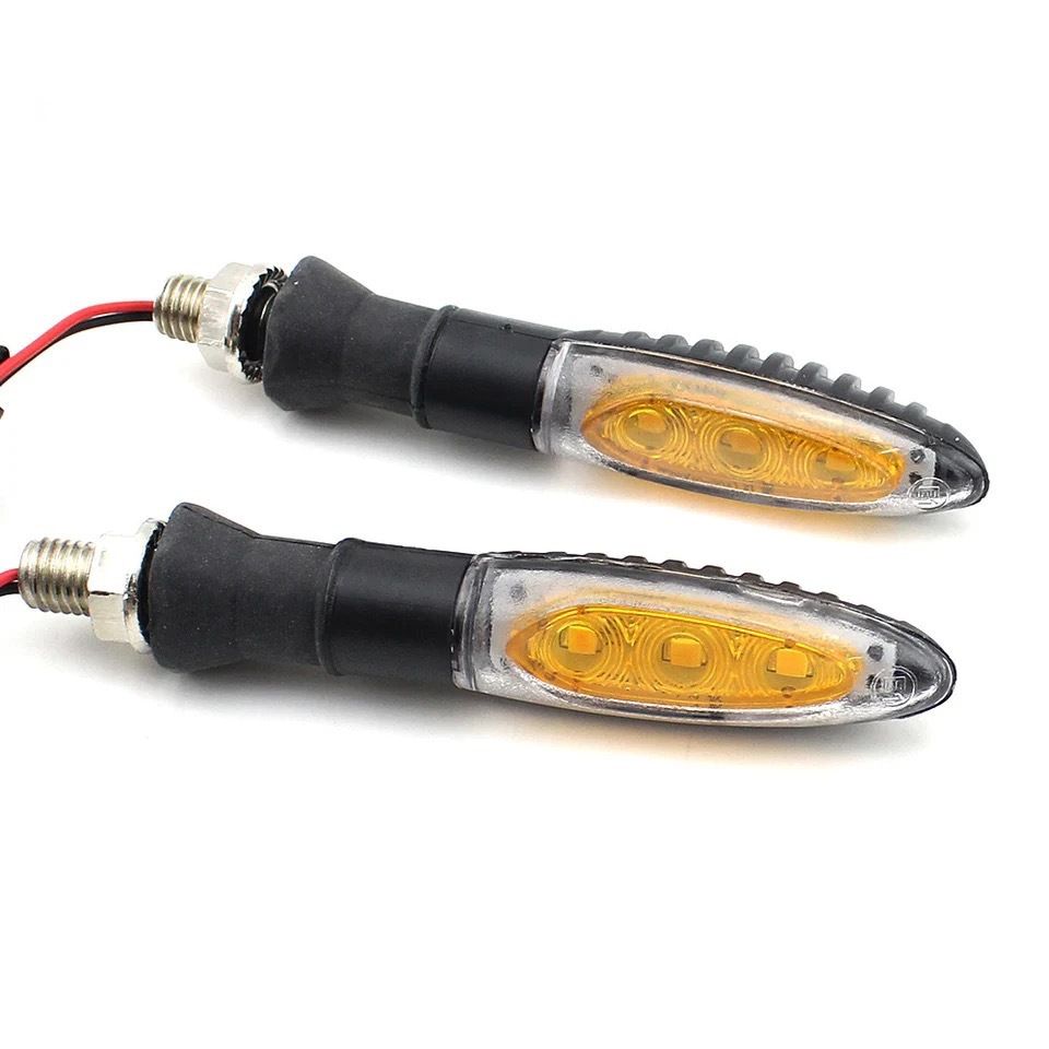 Pair of yellow LED motorcycle turn signals from Everything Baby, showing front and rear flashing signal lights on a bike.