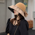 Foldable anti-UV ribbon sun hat for women, packable beach straw hat with wide brim for sun protection and style.