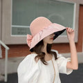 Foldable anti-UV ribbon sun hat for women, packable beach straw hat with ribbon shade, ideal for sun protection at the beach.