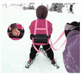 Pink children's skiing safety belt and harness from Everything Baby, designed for ski training and skateboarding support.