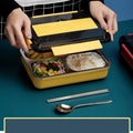 Stainless steel bento box with four compartments, insulated bag, and cutlery, designed for adults and work lunches.
