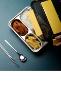 Stainless steel bento lunch box with four compartments, insulated bag, and cutlery, suitable for adults and work meals.