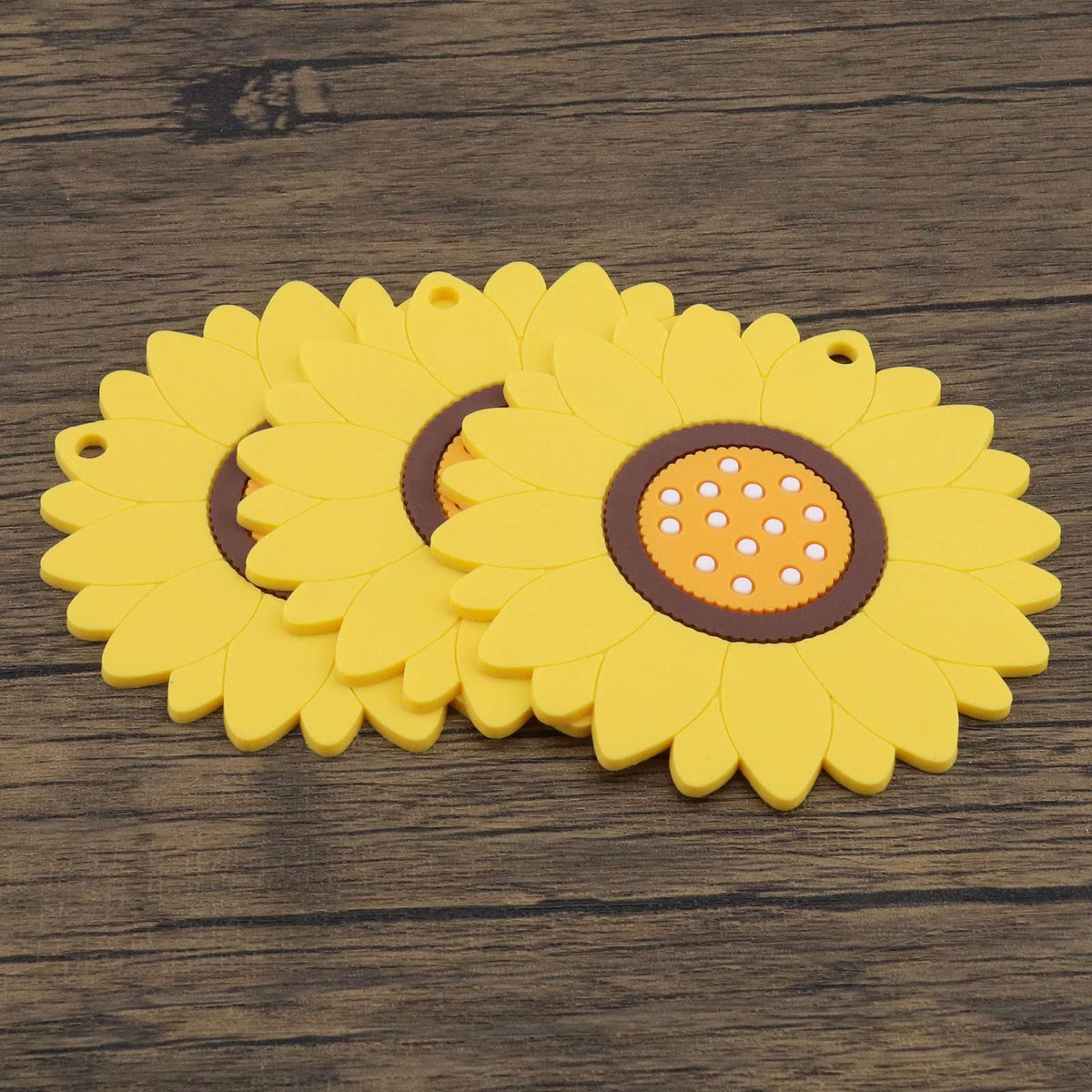 Three yellow sunflower-shaped coasters with floral design, heat insulation mats for hot and cold drinks, by Everything Baby.