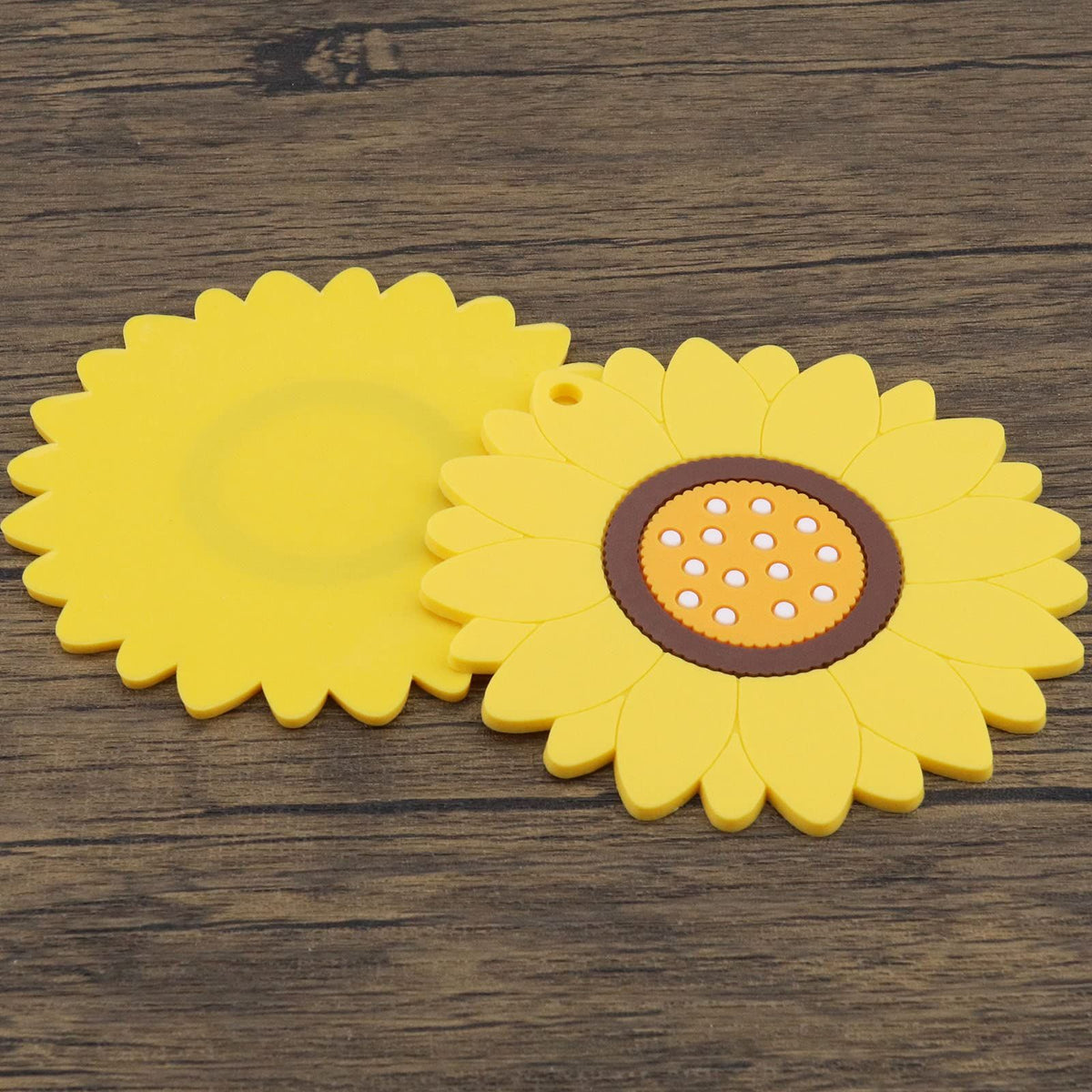 Set of three yellow sunflower-shaped coasters for hot and cold drinks, heat insulation mats, ideal as home table accessories.