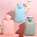 Set of three colorful rubber hot water bottles for pain relief and therapy, suitable for adults and kids, by Everything Baby.