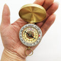 Gold brass pocket compass for camping and hiking, outdoor navigation tool, suitable for wilderness and outdoor play activities.