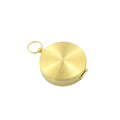 Gold brass pocket compass for camping and hiking, used for outdoor navigation and wilderness survival.
