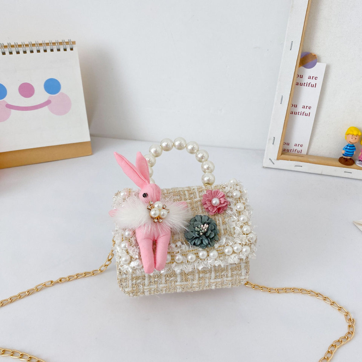 Cute girls princess purse with crown design, pearl handle, bunny cartoon details, perfect for toddlers and young kids.