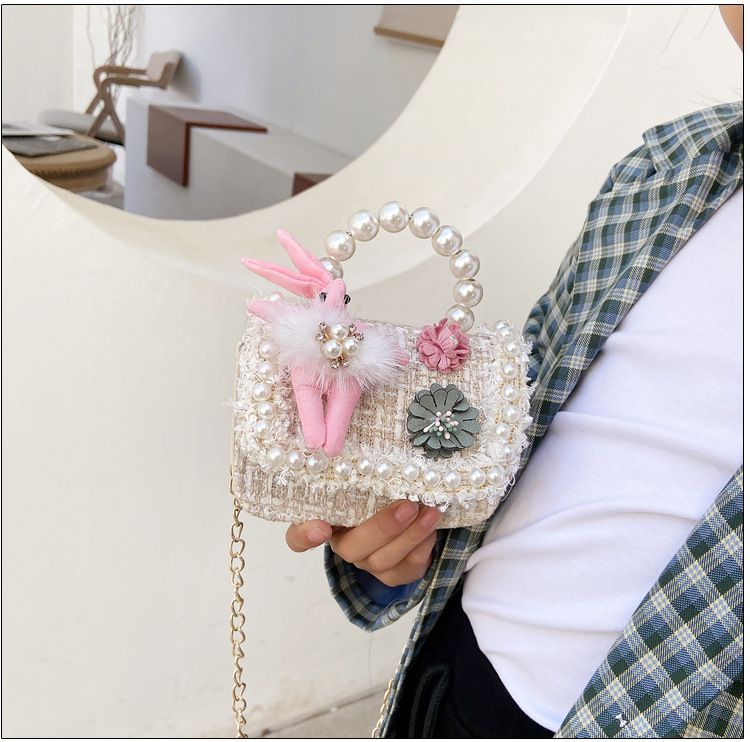 Cute girls' princess crossbody purse with crown design, pearl handle, bunny accents, perfect for toddlers and kids.
