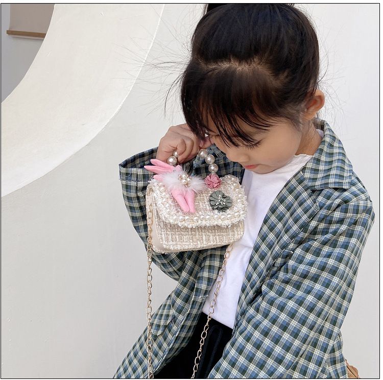Cute girls' princess purse with crown design, pearl handle, and bunny cartoon details, perfect for toddlers and kids.