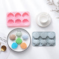 Two silicone shell-shaped ice cube trays for chocolates, soaps, or wax melts, featuring easy-release non-stick design.