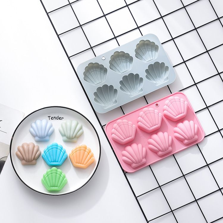 Two silicone shell-shaped ice cube trays with easy-release, non-stick surface, ideal for chocolates, soaps, and crafts.