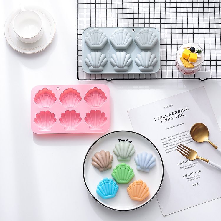Two silicone shell-shaped ice cube trays for chocolates, soaps, and wax melts, featuring easy-release non-stick design.