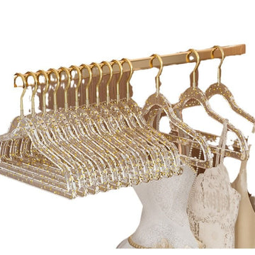 Set of 10 clear plastic hangers with gold glitter non-slip coating for boys' sleepwear, ideal for organizing children's clothing.