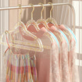 Set of 10 clear plastic hangers with gold glitter non-slip coating for baby boys' sleepwear, ideal for organizing children's clothing.