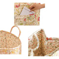 Cotton quilted floral foldable storage basket with handles, used as a portable toy or laundry organizer for kids' room storage.
