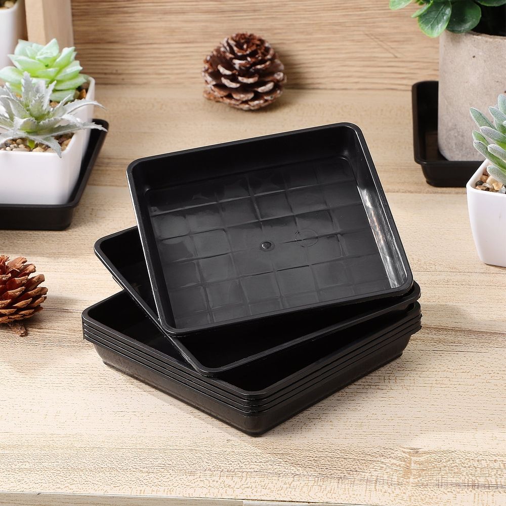 Black plastic square flower pot trays for indoor and outdoor planters, designed for versatile use and easy drainage.