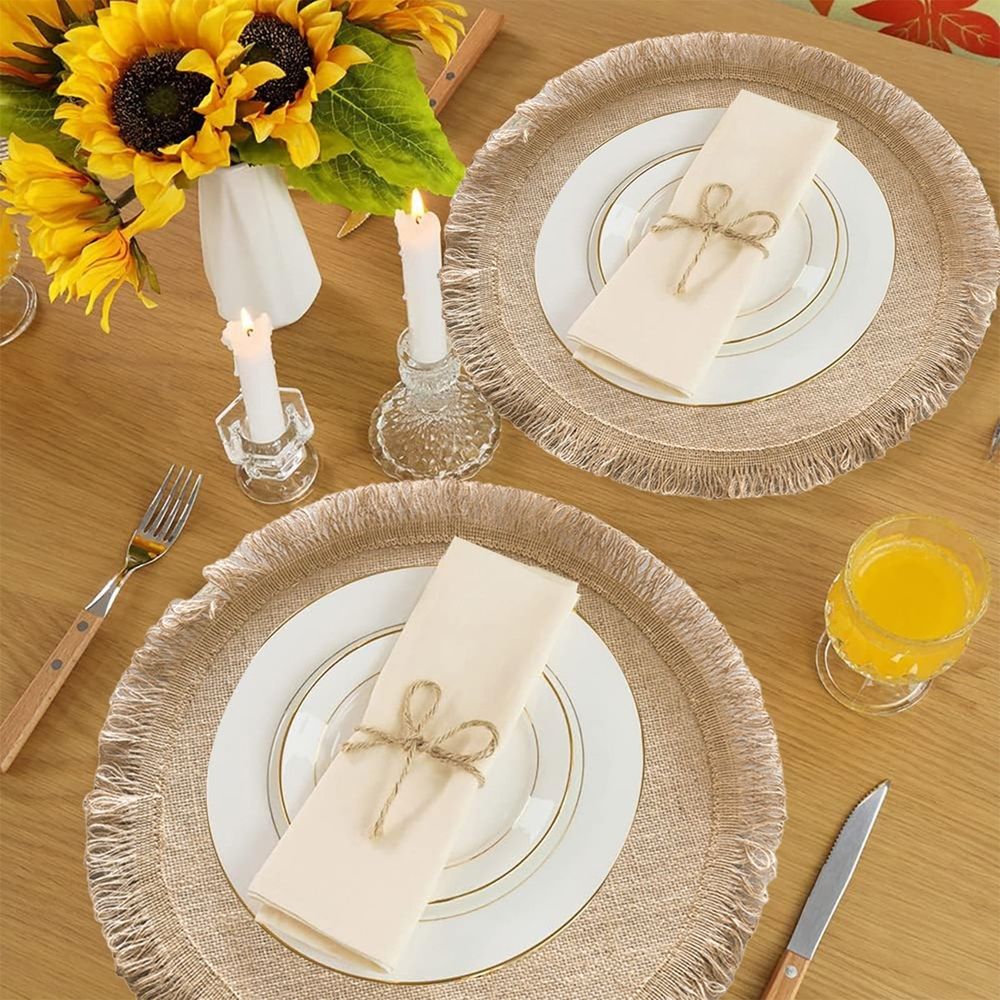 Round jute placemat with tassel fringe from Everything Baby, natural linen material, heat-resistant, ideal for dining table decor.