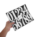 White mailbox address numbers set by Everything Baby, easy to install, designed for a clean look in home or mailbox decor.