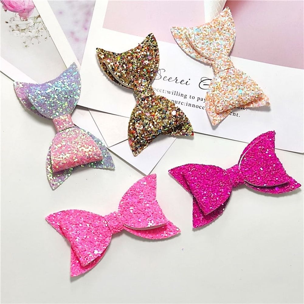 Five colorful glitter hair bows for baby girls and toddlers, featuring sequins and large designs, from Everything Baby.