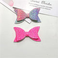 Five colorful glitter hair bows for baby girls and toddlers, featuring large sequins and boutique style clips.