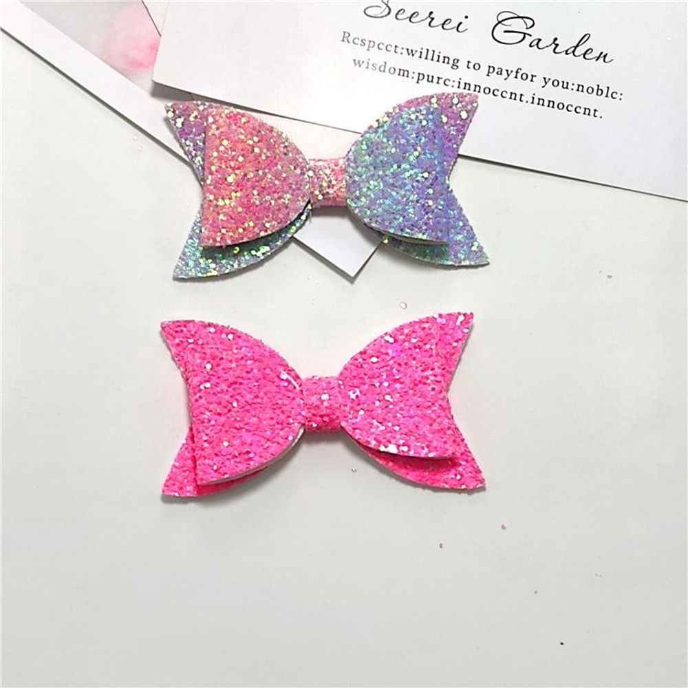 Five colorful glitter hair bows for baby girls and toddlers, featuring large sequins and boutique style clips.