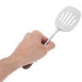 Stainless steel slotted shovel with silver plating, ideal for outdoor play and food serving, shown in a child's outdoor toy setting.