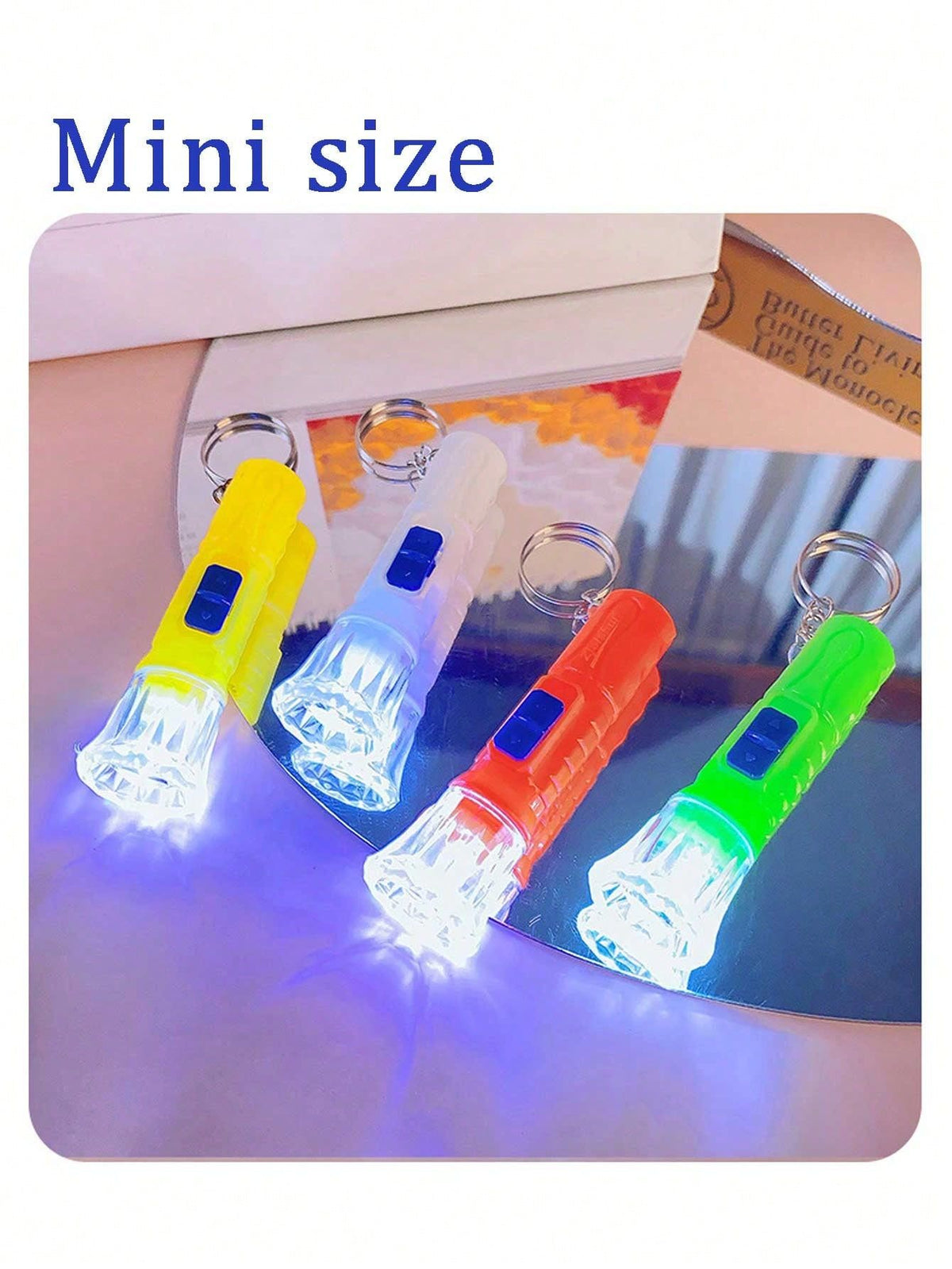 12-pack mini LED flashlights from Everything Baby, keychain pendant design in four colors, ideal as party favors or classroom prizes.