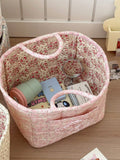 White floral print quilted storage basket with handle, large capacity toy and laundry organizer for kids' room or nursery.