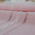 Pink boho style rectangular tablecloth with tassel stripe pattern on woven polyester fabric, ideal for dressers, bedside tables, or cabinets.