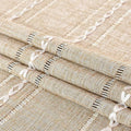 Boho brown rectangular tablecloth with tassel stripe pattern on a dresser or bedside table, polyester woven home decor accessory.