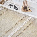 Boho-style brown rectangular polyester tablecloth with tassel stripe pattern on a small dresser or bedside table, 38x91cm.