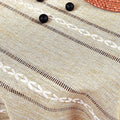 Boho style brown rectangular tablecloth with tassel stripe pattern, polyester woven desk cover on a dresser or bedside table.