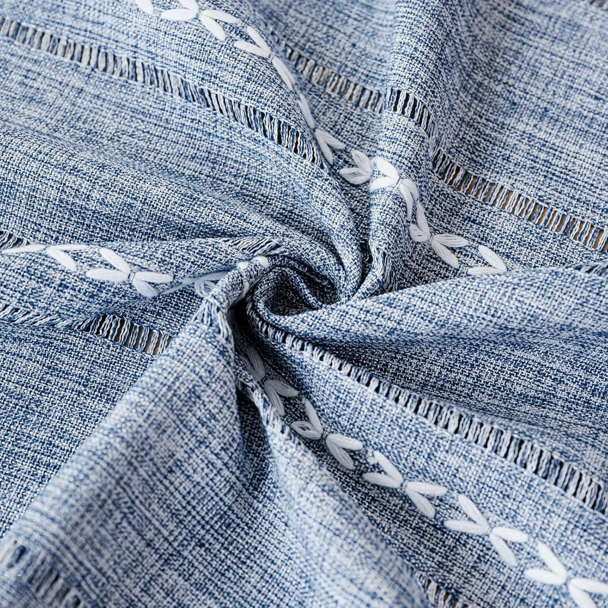 Blue boho-style rectangular tablecloth with tassel stripe pattern, polyester woven fabric on a kid's dresser or bedside table.