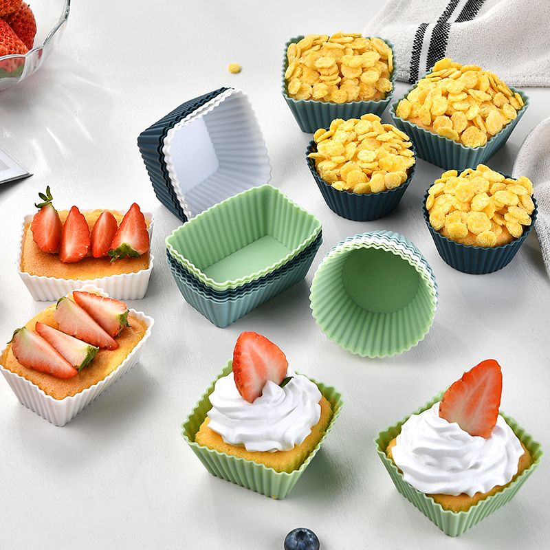 Silicone cupcake liners with three shapes, reusable baking cups for muffins, pastries, and cake molds, designed for kids' lunch boxes.