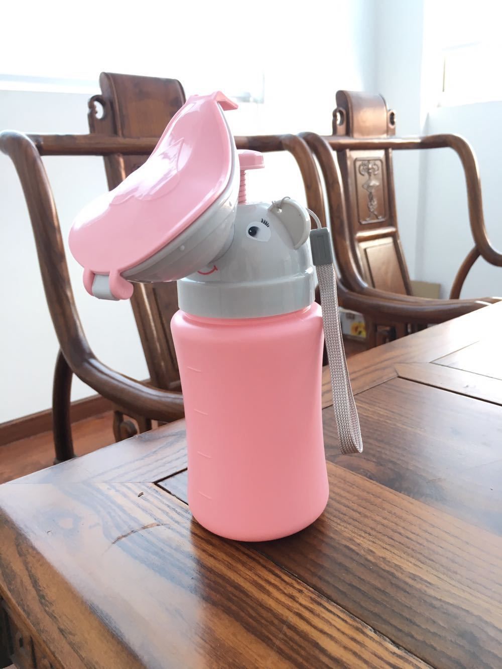 Pink portable travel urinal for girls, emergency potty for camping, car travel, and potty training, by Everything Baby.