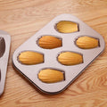 Everything Baby 6-cavity non-stick oval shell mold cake pan for baking cookies and treats in oven, ideal for kids' pretend play.
