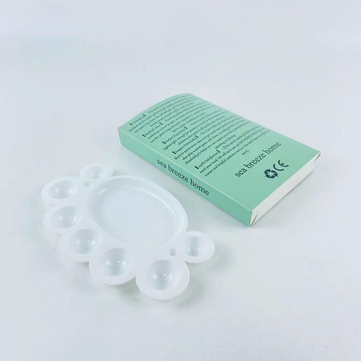 Plastic paint palette for artists, with multiple wells for mixing colors, ideal for painting and art projects.