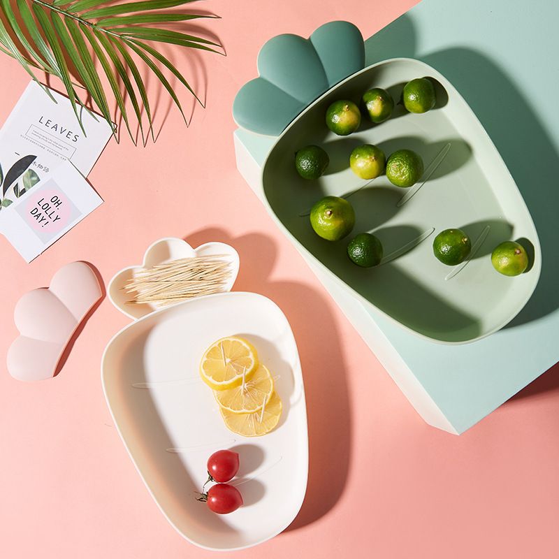 Two plastic fruit bowls and snack trays for kids, featuring colorful melon seeds and candy designs, perfect for pretend play.