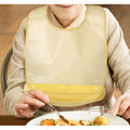 Silicone waterproof clothing protector with food catcher for adults, reusable and easy to clean, suitable for nursing and feeding.