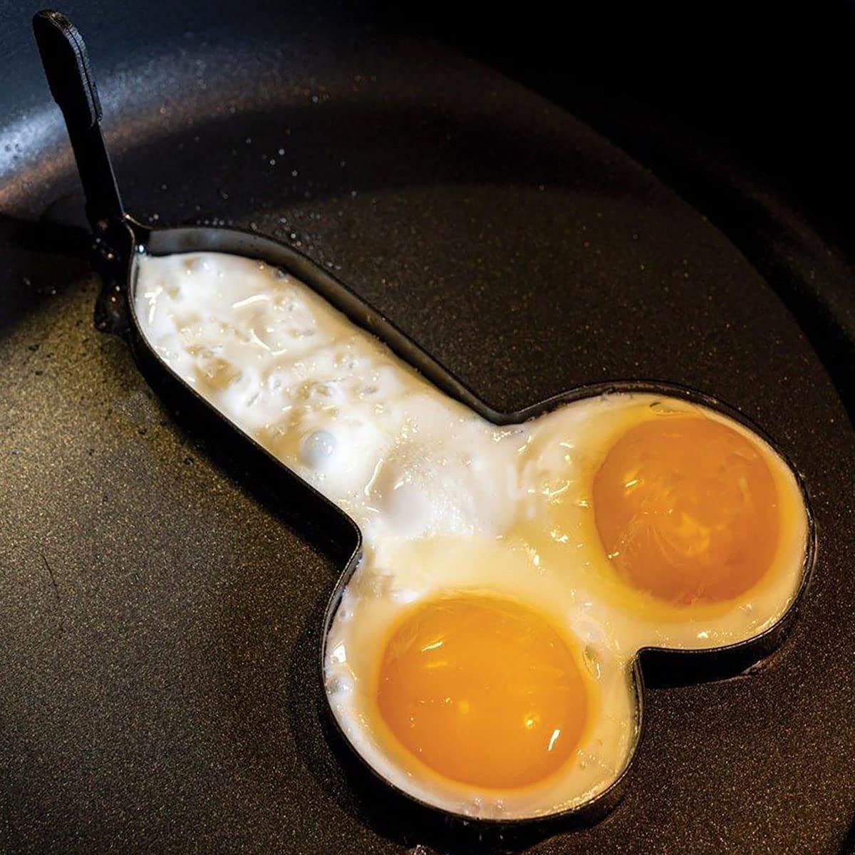 Stainless steel funny egg rings with foldable handle, shaped like white elephants, for playful egg cooking in the kitchen.