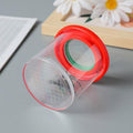 Child holding a bug viewer magnifier from the Backyard Explorer insect collecting kit, designed for outdoor insect observation.
