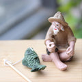Resin garden ornament of a sitting old man figure, suitable for outdoor garden, pool, or micro-landscape decoration