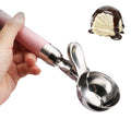 Pink stainless steel ice cream scoop with trigger, perfect for making fruit or melon balls in the kitchen.