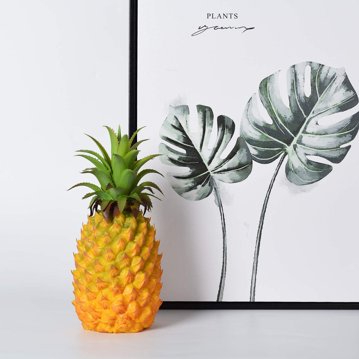 Realistic artificial pineapple toy for pretend play, suitable for home decor and kids' play areas, by Everything Baby.