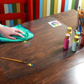 Transparent plastic dining table cover with protective mat for wooden furniture, ideal for baby and kids' pretend play.
