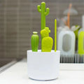 Baby bottle brush set from Everything Baby with bottle, nipple, detail, and straw brushes on a drying rack for baby bottle cleaning.
