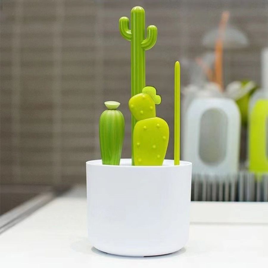 Baby bottle brush set from Everything Baby with bottle, nipple, detail, and straw brushes on a drying rack for baby bottle cleaning.