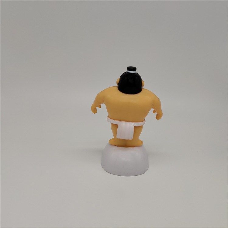 Sumo wrestler solar-powered swinging dashboard ornament for ride-on cars, featuring a playful design by Everything Baby.