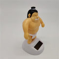 Sumo wrestler solar-powered swinging car dashboard ornament designed for ride-on cars and kids' vehicles.